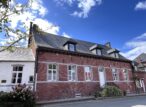 Maison traditionnelle en briques rouges sous ciel bleu