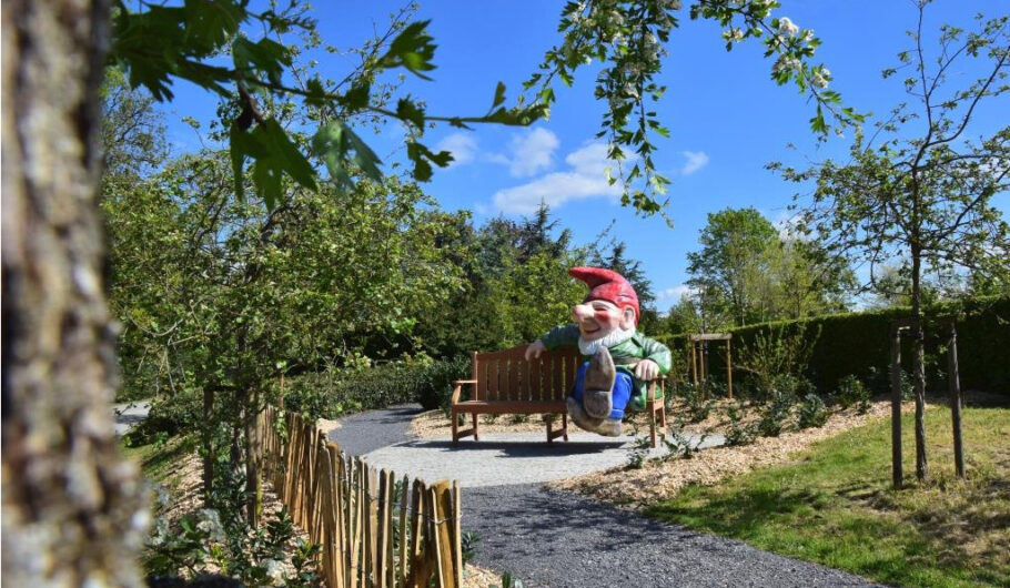 Nain de jardin assis sur un banc ensoleillé